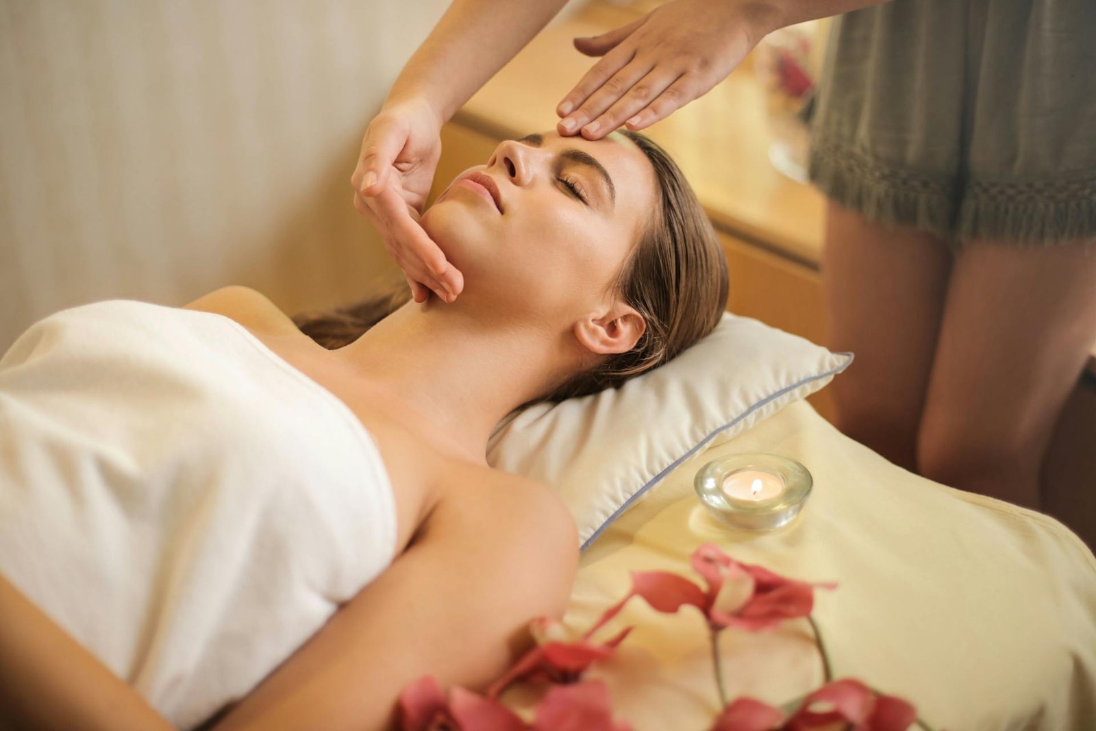 Lit candles and rose petals in Auram Spa's treatment room