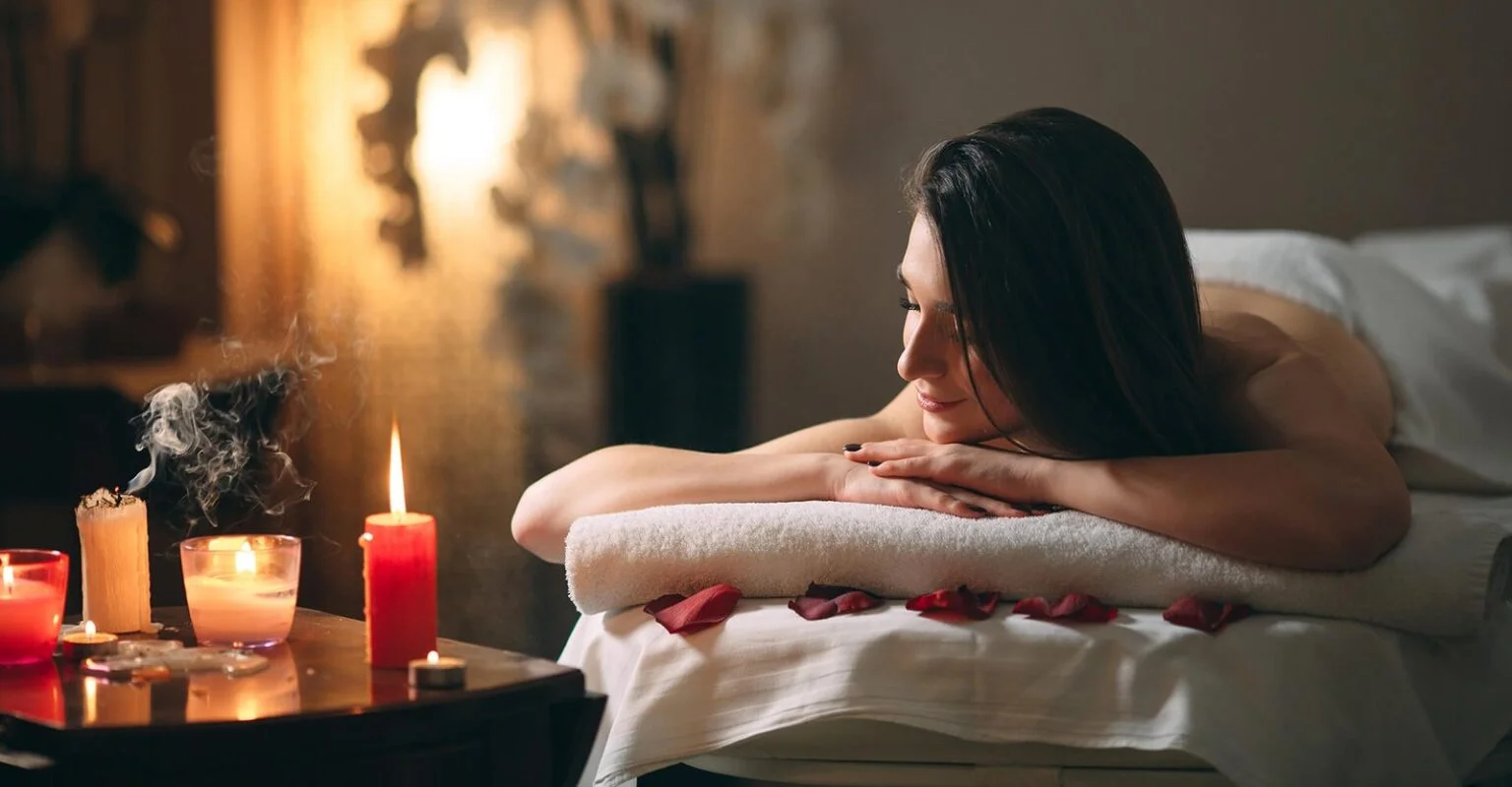 Woman relaxing during a candlelit spa massage at Auram Spa Thane